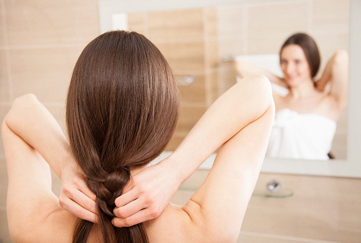 Woman leaving hair braided overnight for beachy wavy hair