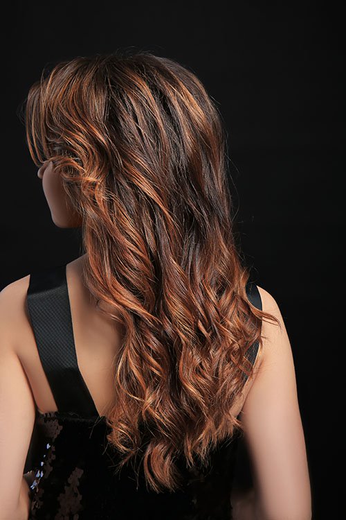 Woman with caramel swirl hair color and highlights