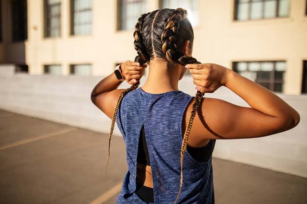woman with dutch braids hairstyle post workout