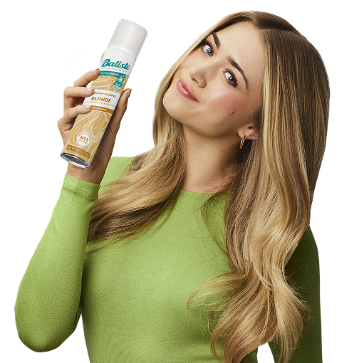 Woman post-styling her hair with dry shampoo.