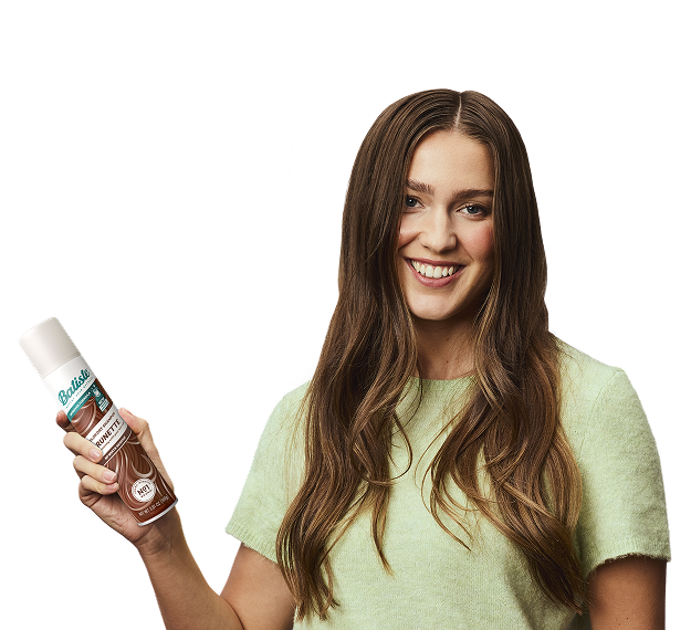 Woman showing how to use dry shampoo.