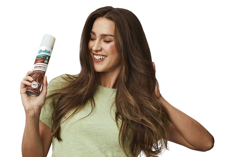 Woman post-styling her hair with dry shampoo.