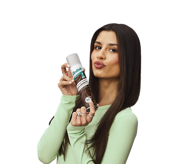 Woman showing how to use dry shampoo.