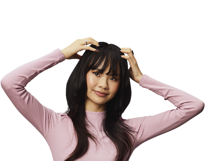 Woman putting hands in hair.