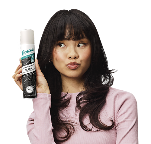 Woman post-styling her hair with dry shampoo.