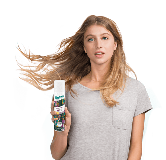 Woman showing how to use dry shampoo.
