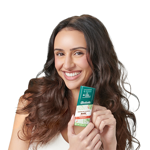 Woman post-styling her hair with dry shampoo.