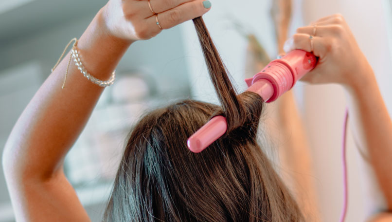 Woman post-styling her hair with dry shampoo.