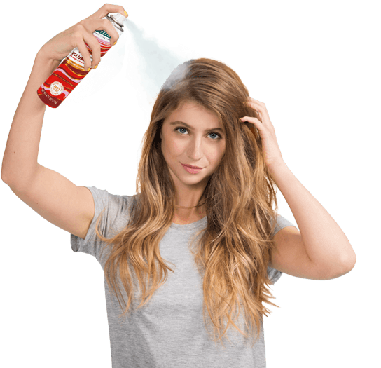 Woman spraying dry shampoo bottle.