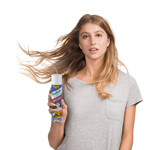 Woman showing how to use dry shampoo.