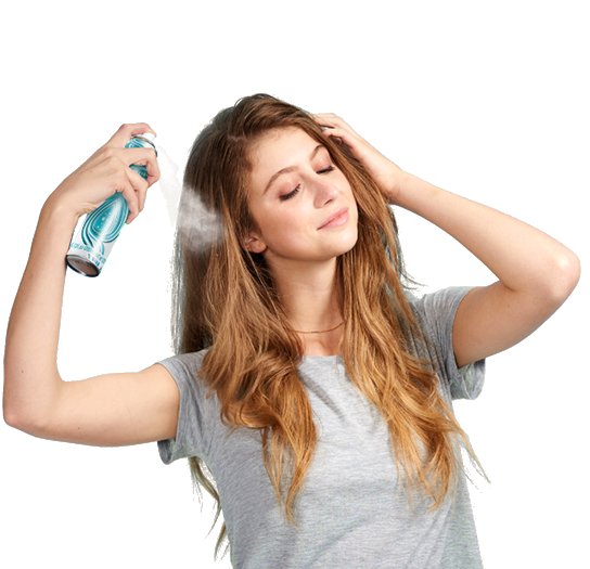 Woman spraying dry shampoo bottle.