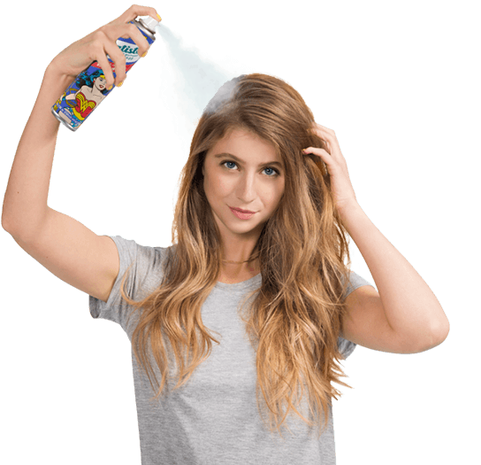 Woman spraying dry shampoo bottle.