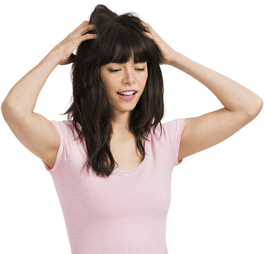 Woman putting hands in hair.